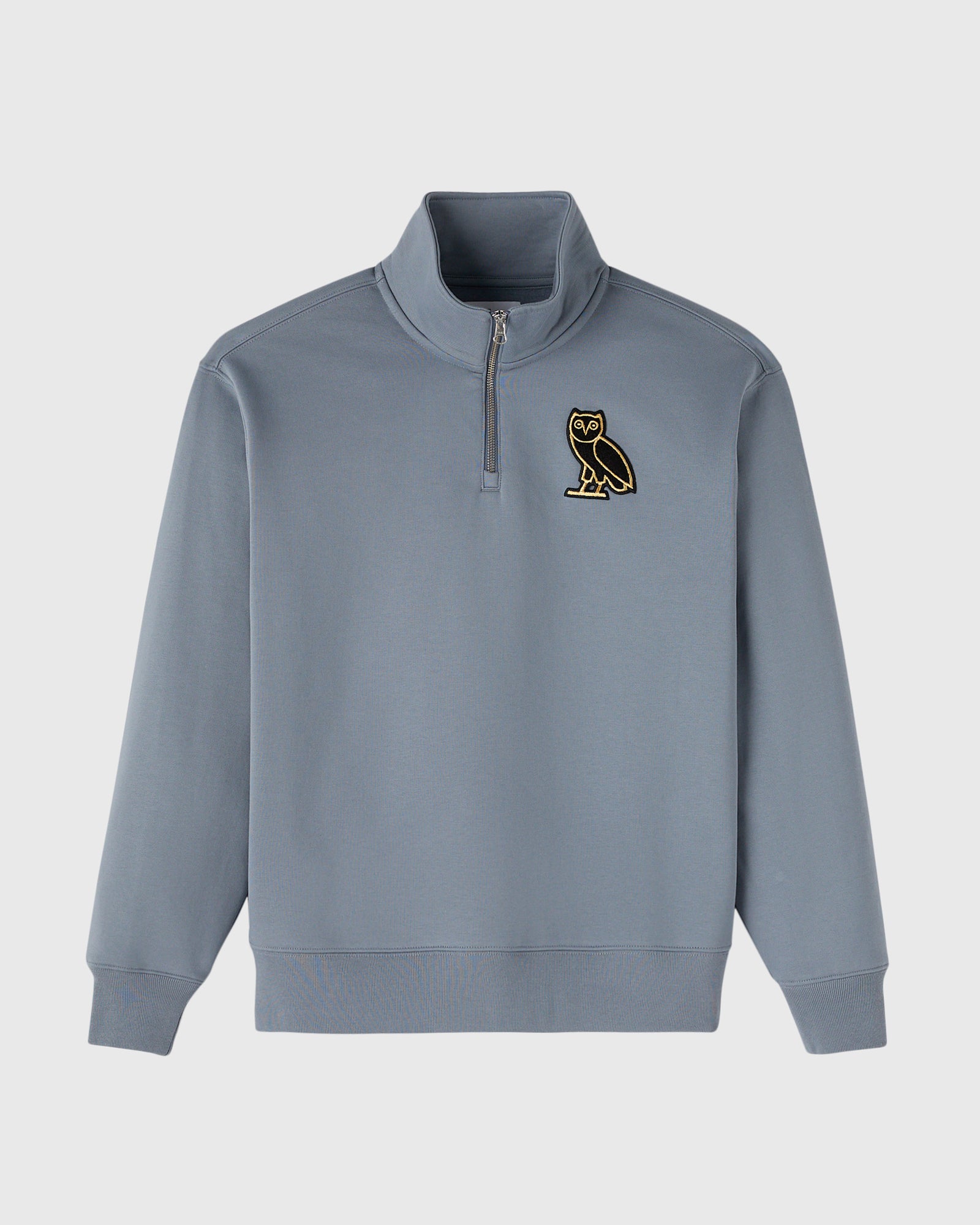 Slate blue quarter-zip mockneck sweatshirt with gold owl emblem on chest.