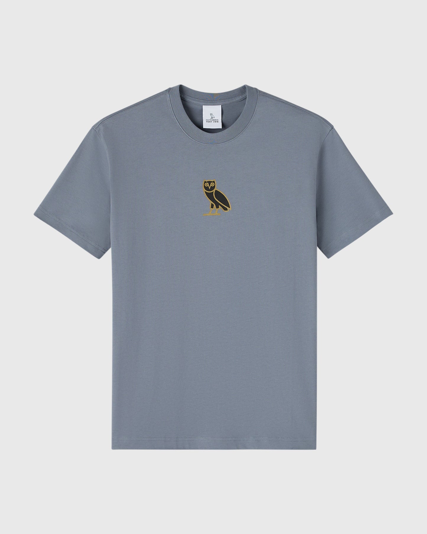 Slate blue crew neck t-shirt with small gold owl embroidery on chest.