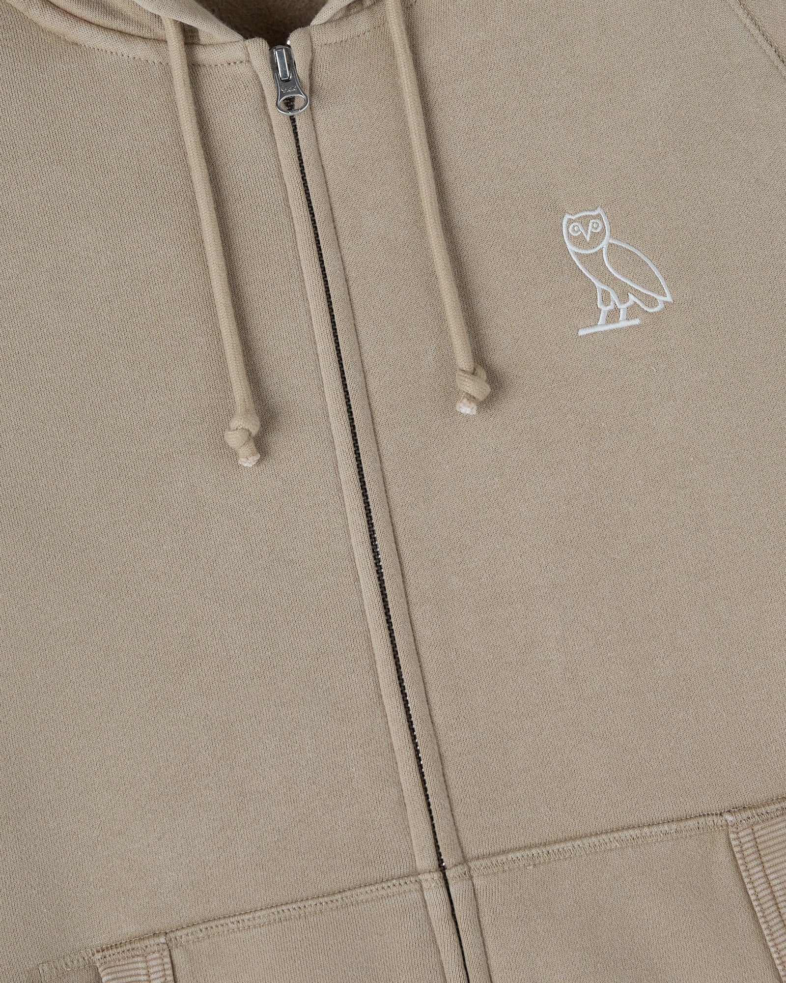 Sandstone raglan hoodie with full-length zipper, drawstring hood, and white owl emblem on chest.