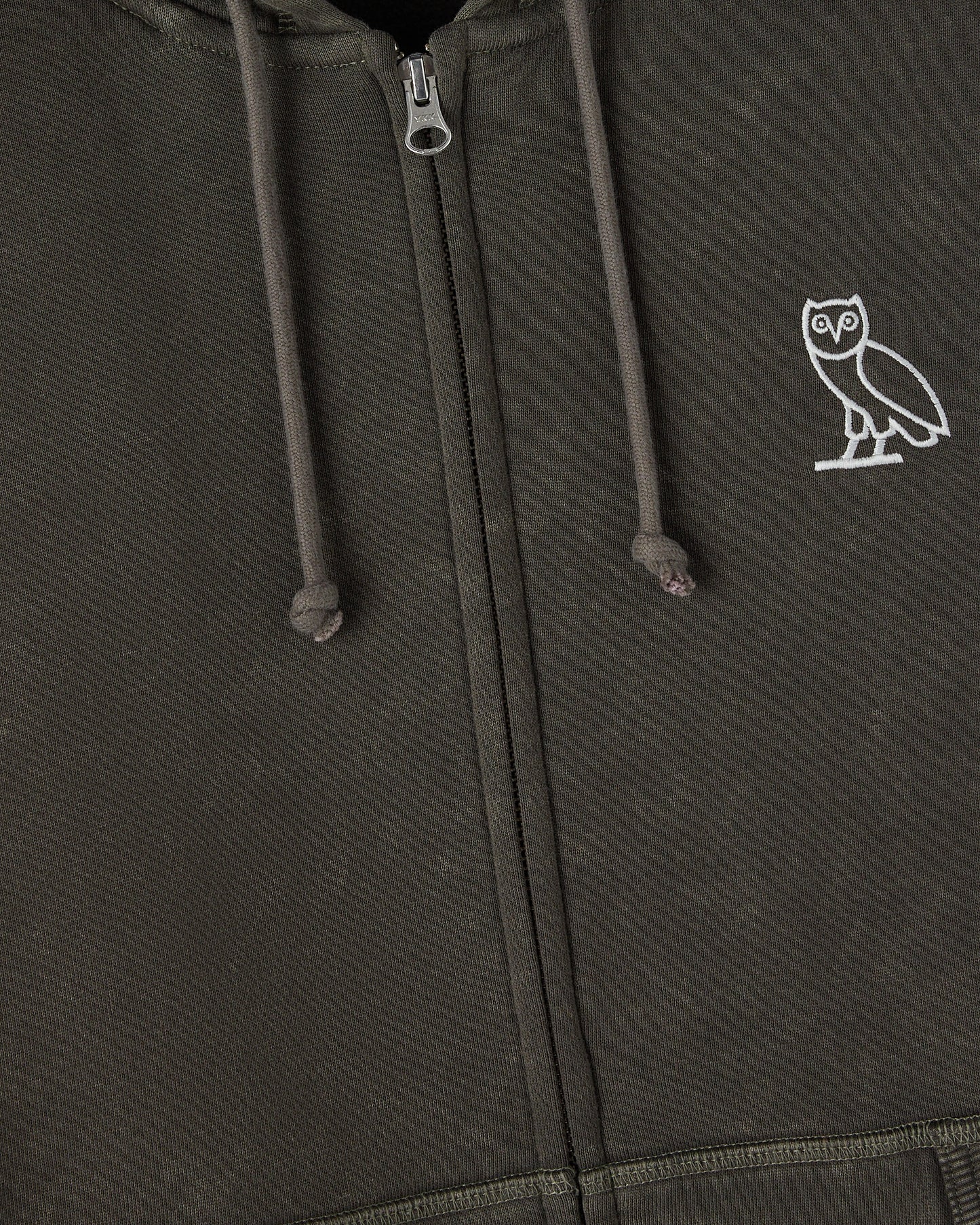 Deep olive full-zip hoodie with white owl embroidery on chest and drawstring hood detail.
