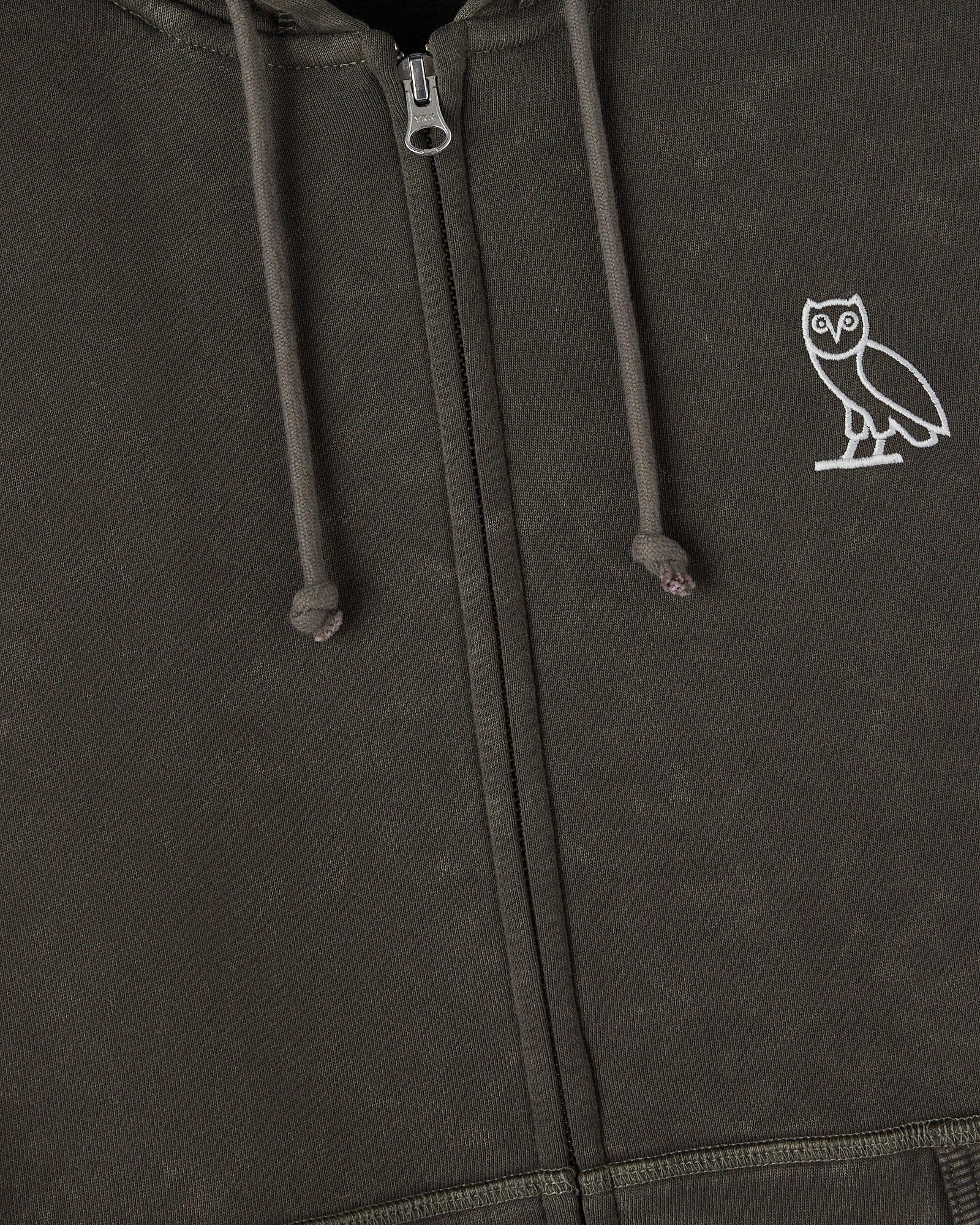 Deep olive full-zip hoodie with white owl embroidery on chest and drawstring hood detail.