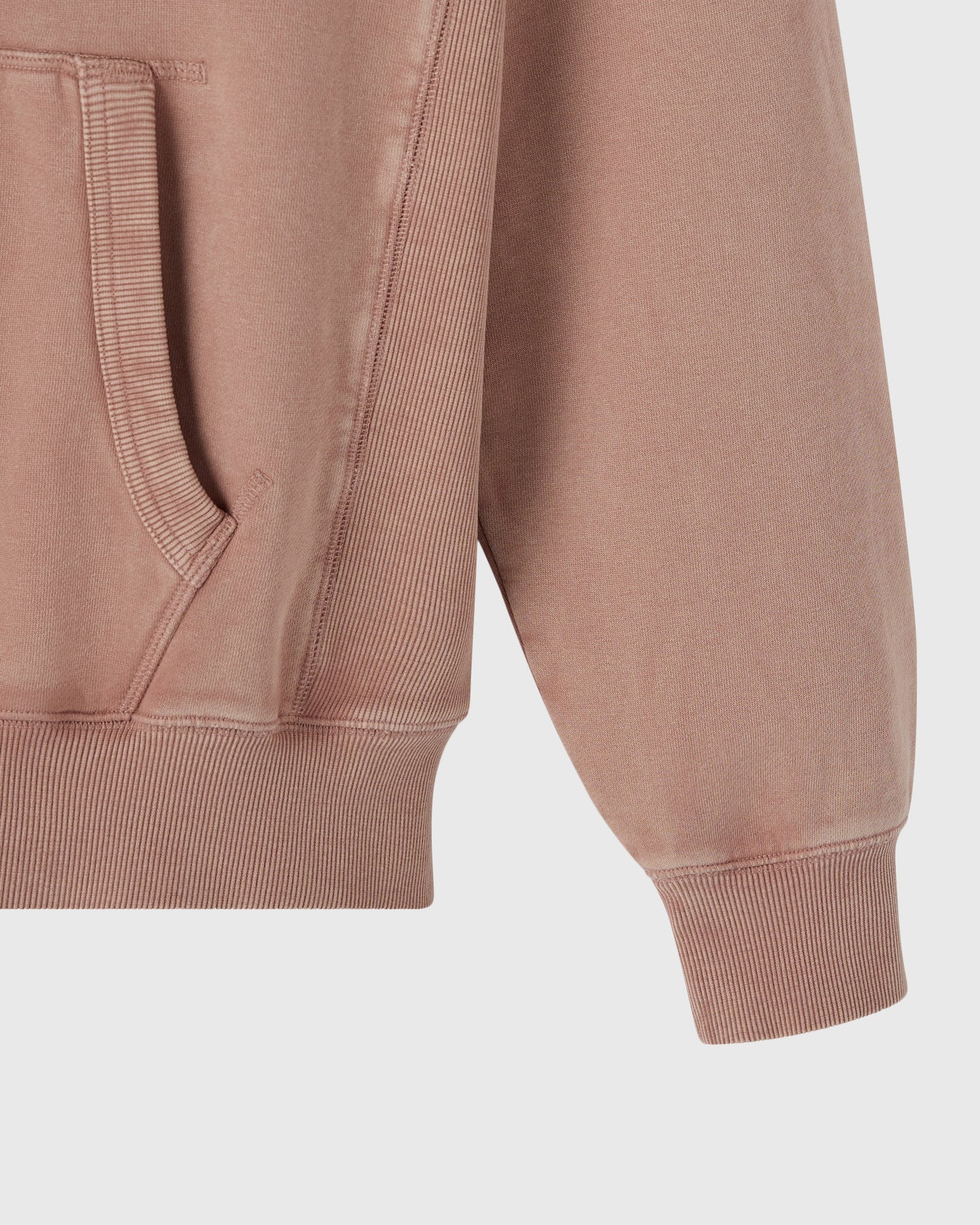 Clay pink raglan hoodie with ribbed cuffs, hem, and kangaroo pocket detail visible on sleeve.