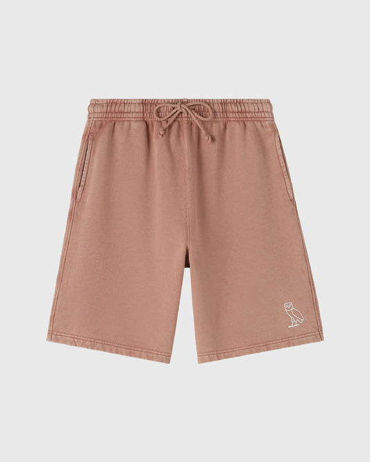 Mauve-pink sweatshorts with elastic waistband, drawstring, side pockets, and small owl embroidery on leg.