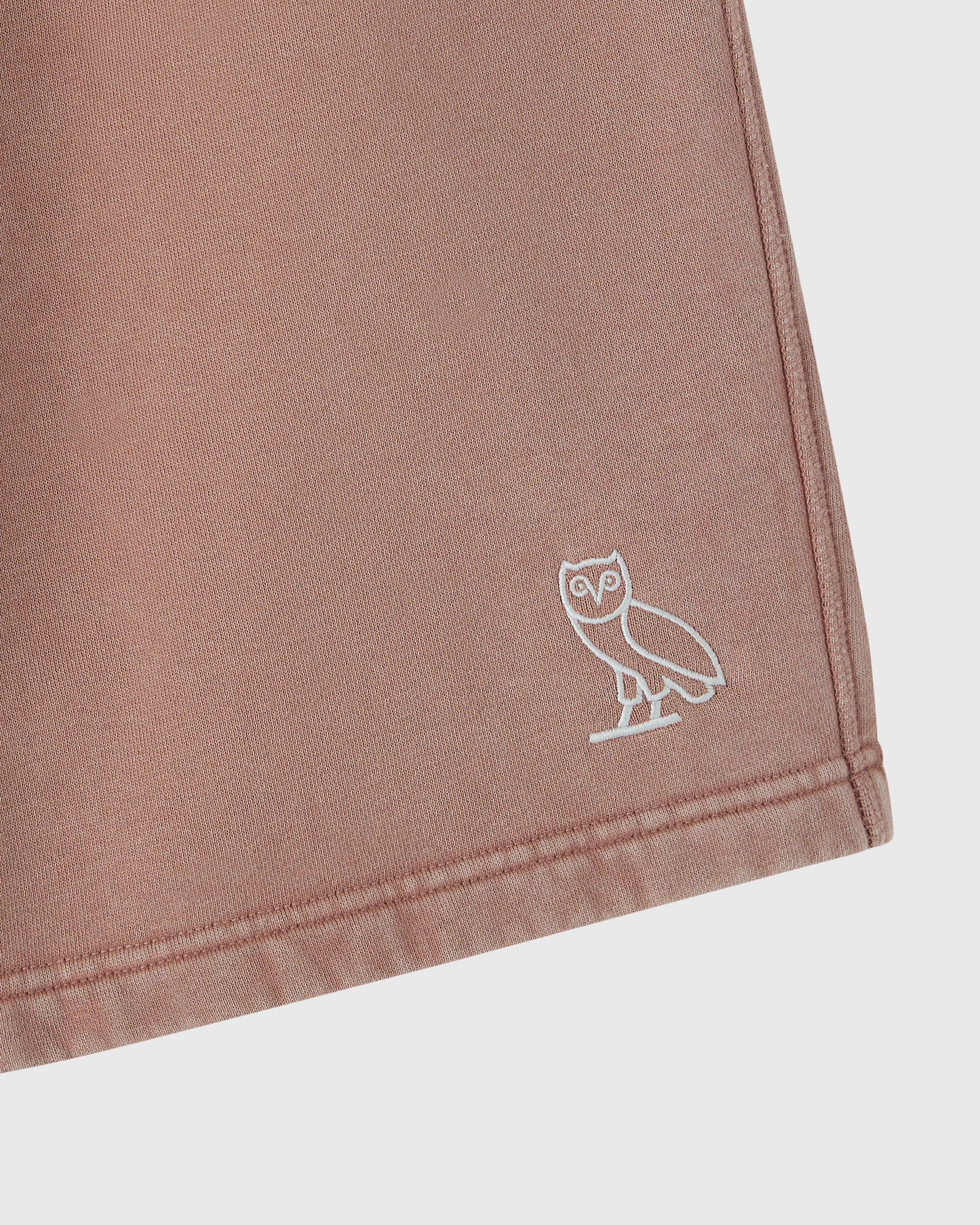 Clay pink sweatshort with white owl embroidery on thigh.