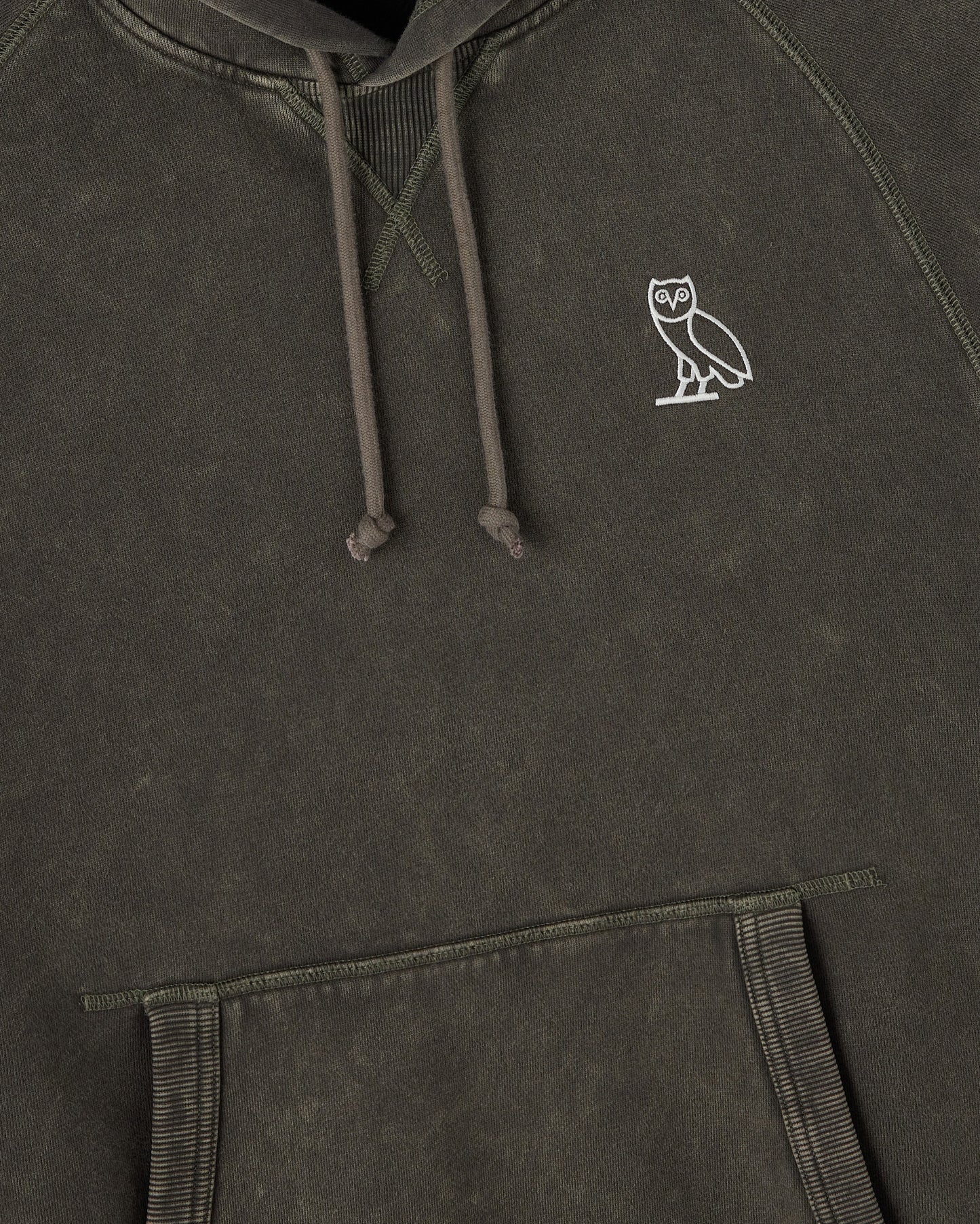 Deep olive raglan hoodie with white owl embroidery on chest and drawstring hood.