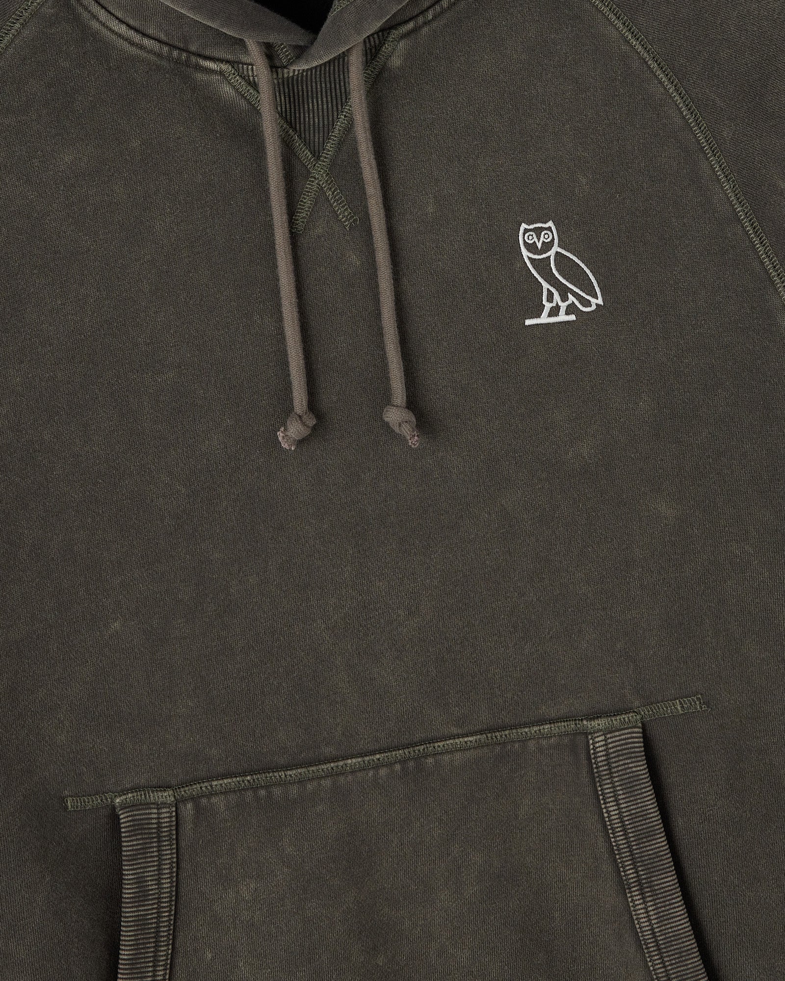 Deep olive raglan hoodie with white owl embroidery on chest and drawstring hood.