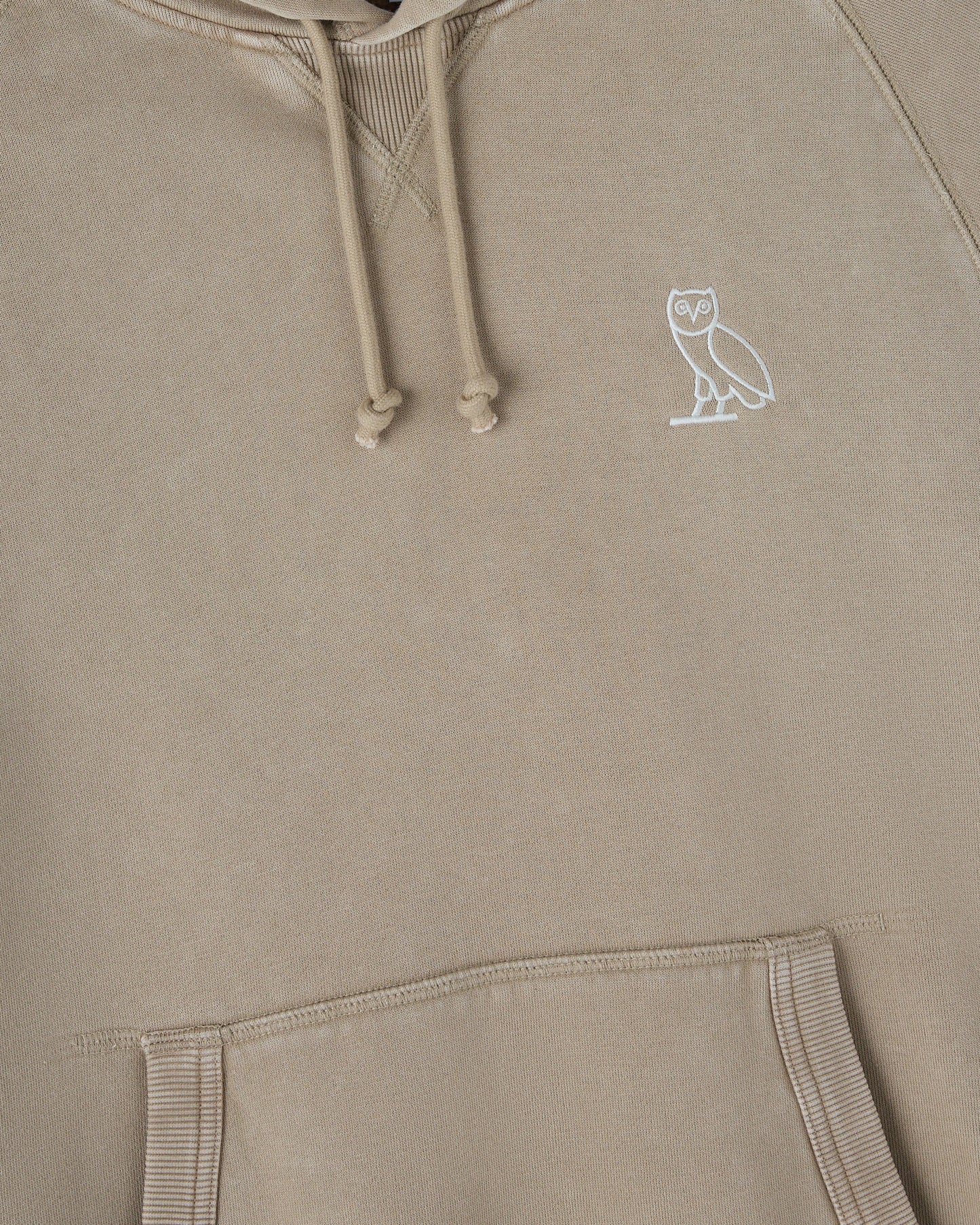 Sandstone raglan hoodie with white owl embroidery on chest and drawstring hood.