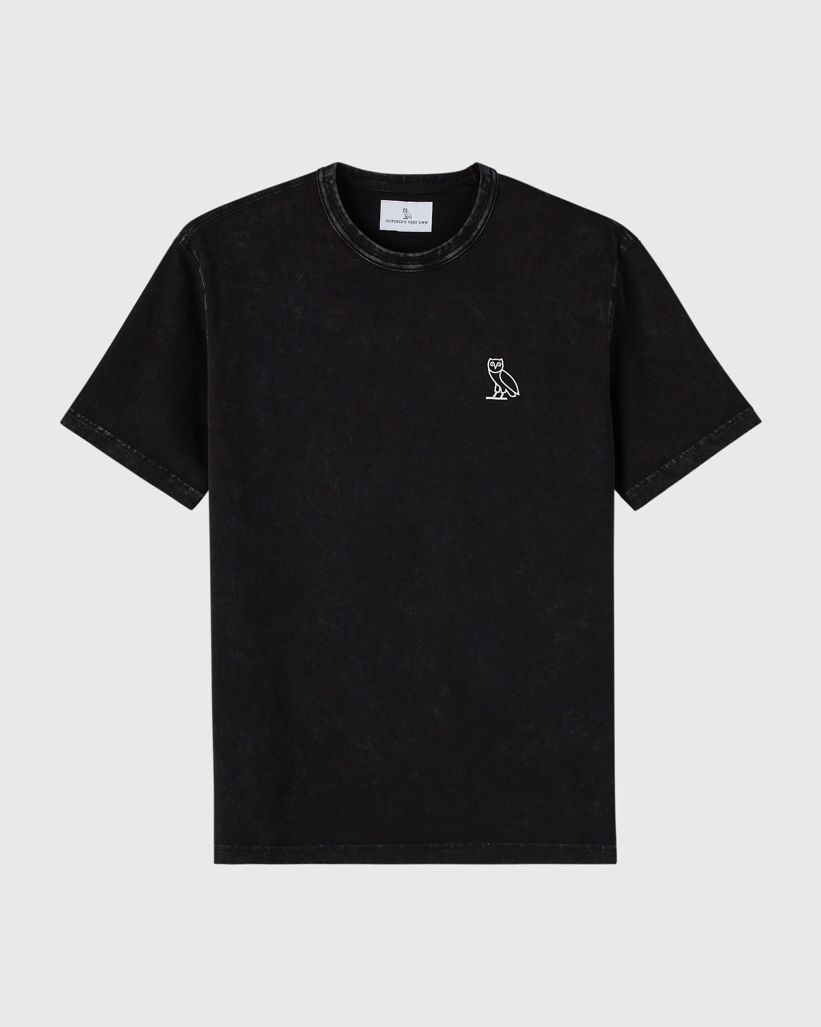 Black garment-dyed t-shirt with small white owl logo on chest and crew neckline.