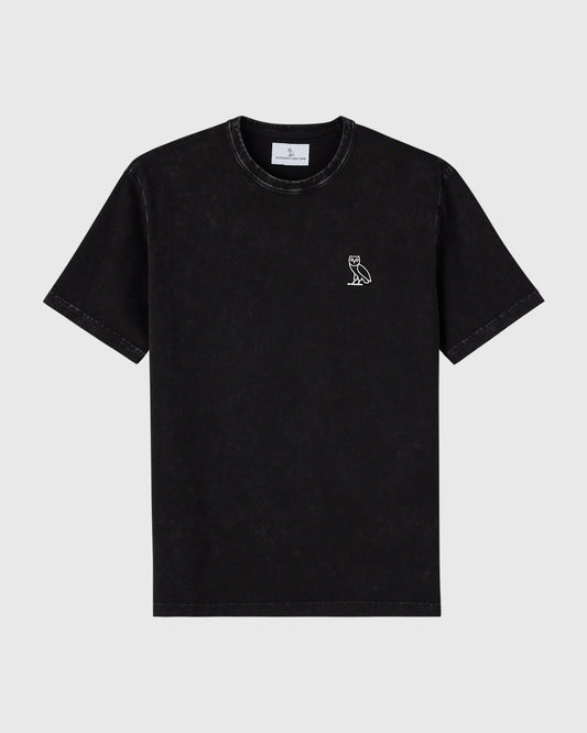 Black garment-dyed t-shirt with small white owl logo on chest and crew neckline.
