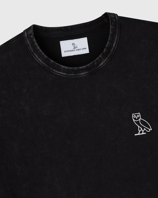 Black crewneck t-shirt with white owl embroidery on chest and brand label visible at neckline.