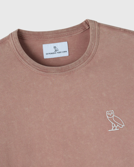 Clay pink long-sleeve crewneck tee with white owl embroidery on chest and brand label visible at neckline.