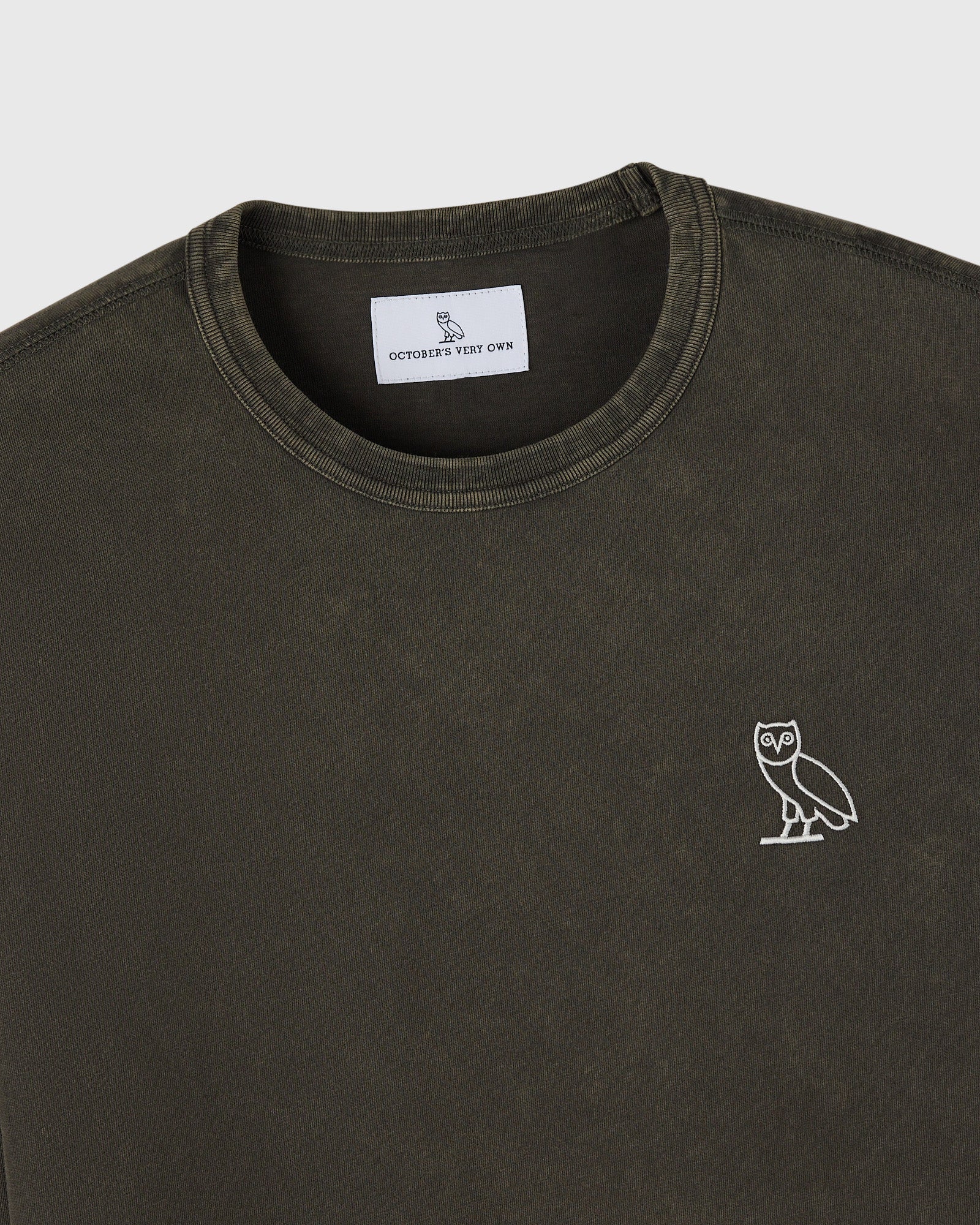 Deep olive long-sleeve tee with crew neckline and white owl embroidered on chest.