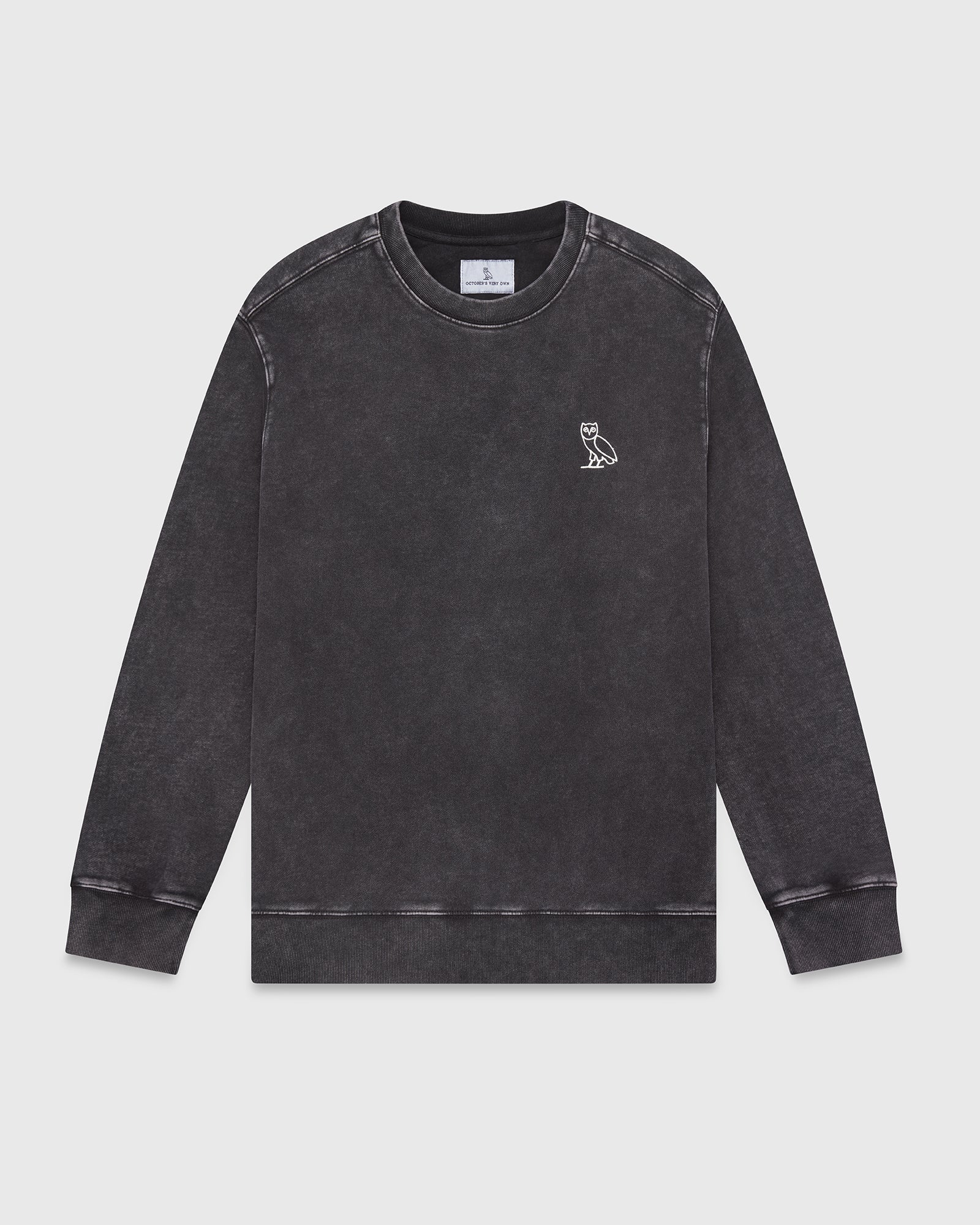 Charcoal garment-dyed crewneck sweatshirt with small owl embroidery on chest and ribbed cuffs.