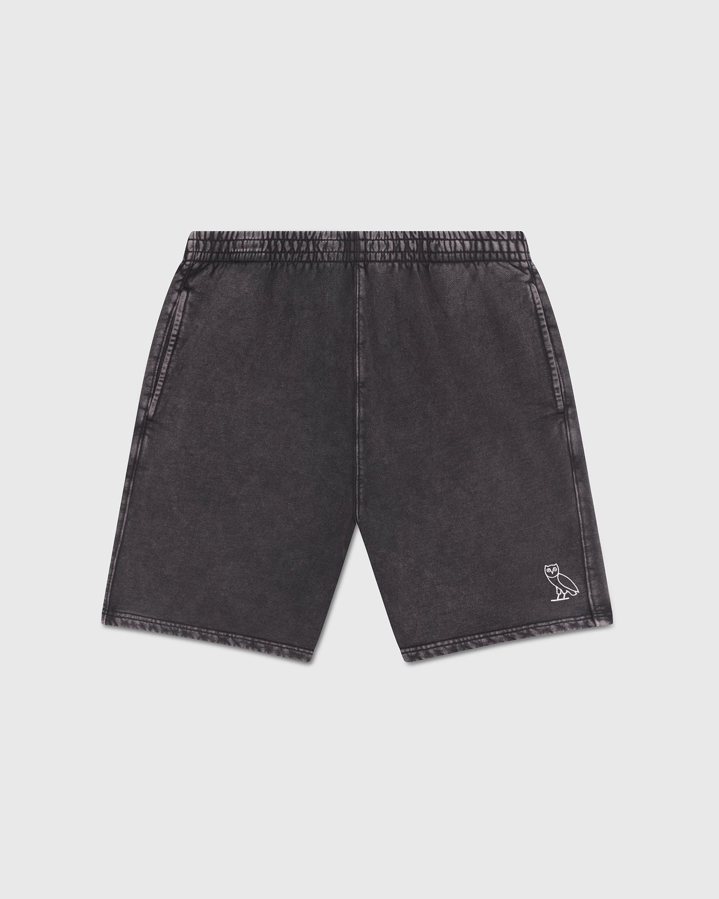 Charcoal garment-dyed shorts with elastic waistband, side pockets, and small owl logo on right leg.