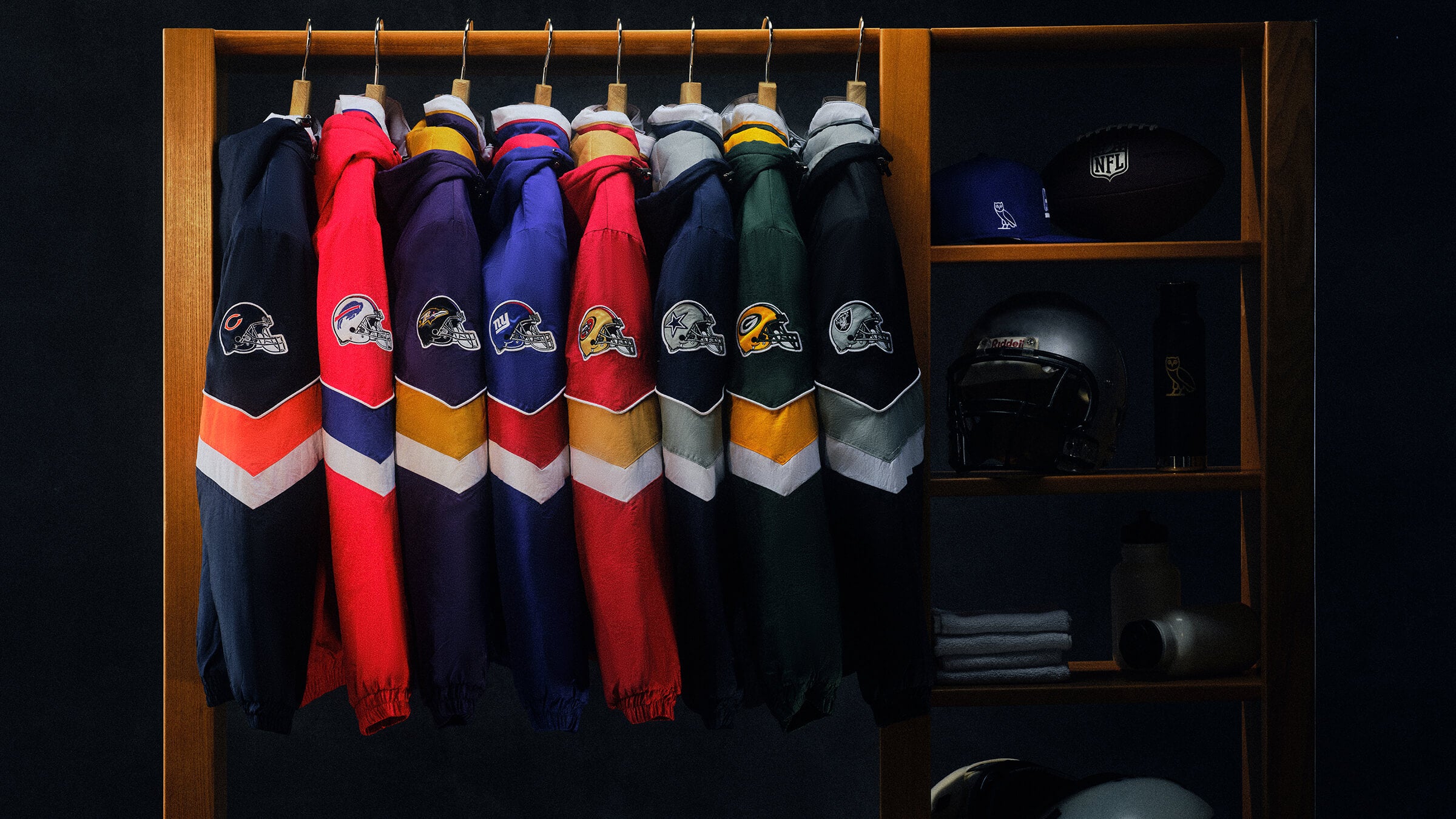 October's Very Own x NFL jackets hung up on a rack with a shelf