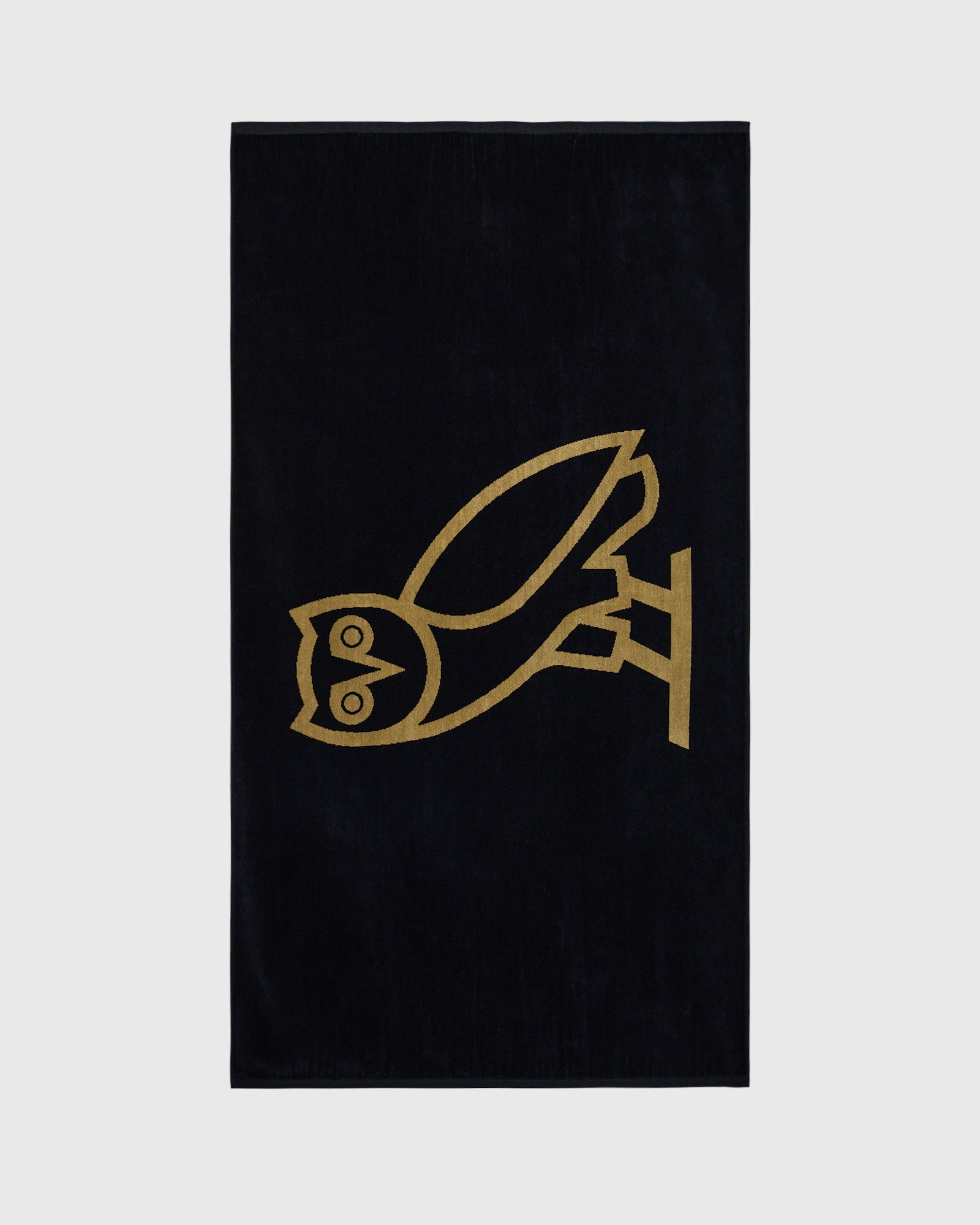 Black towel with gold line-drawn bird design in center.