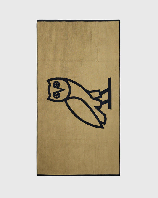 Tan towel with black border and black owl line drawing design.