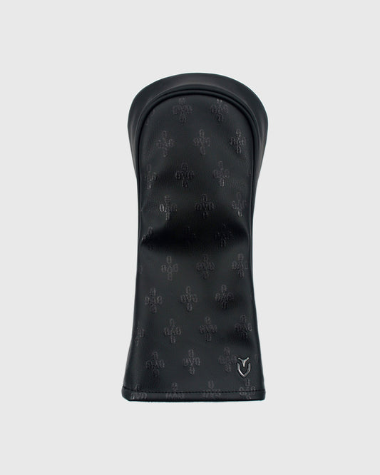 Black golf driver headcover with repeating monogram pattern and Vessel logo.