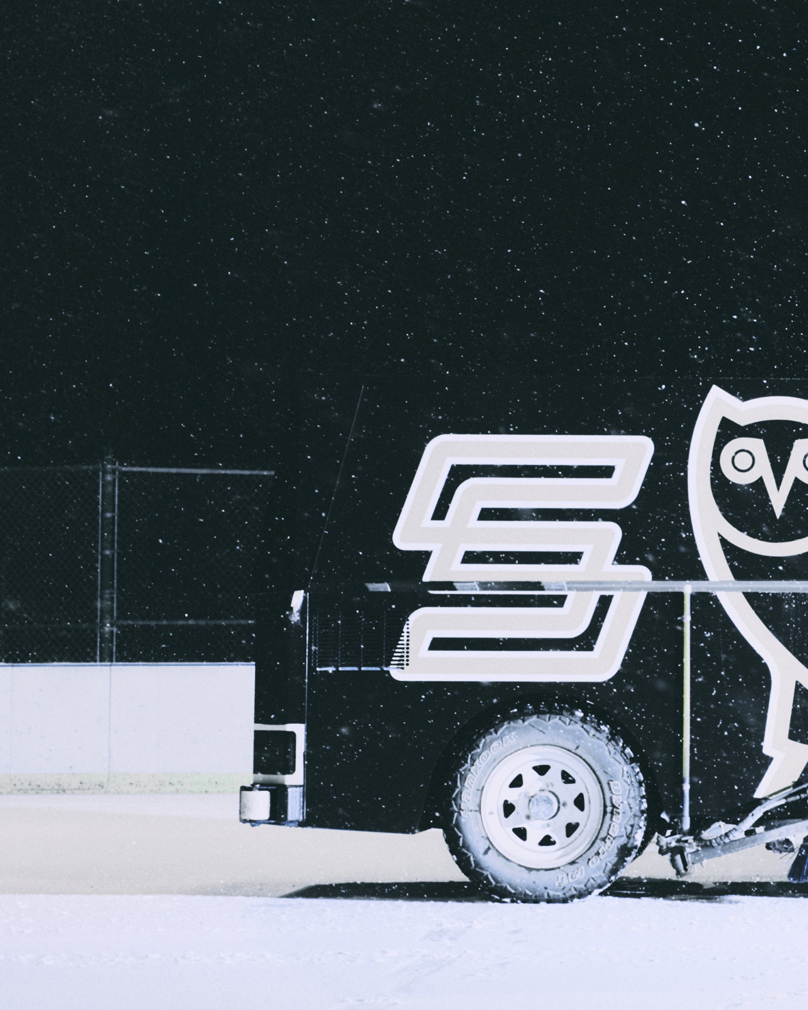 Zamboni with the October's Very Own logo on a snowy background