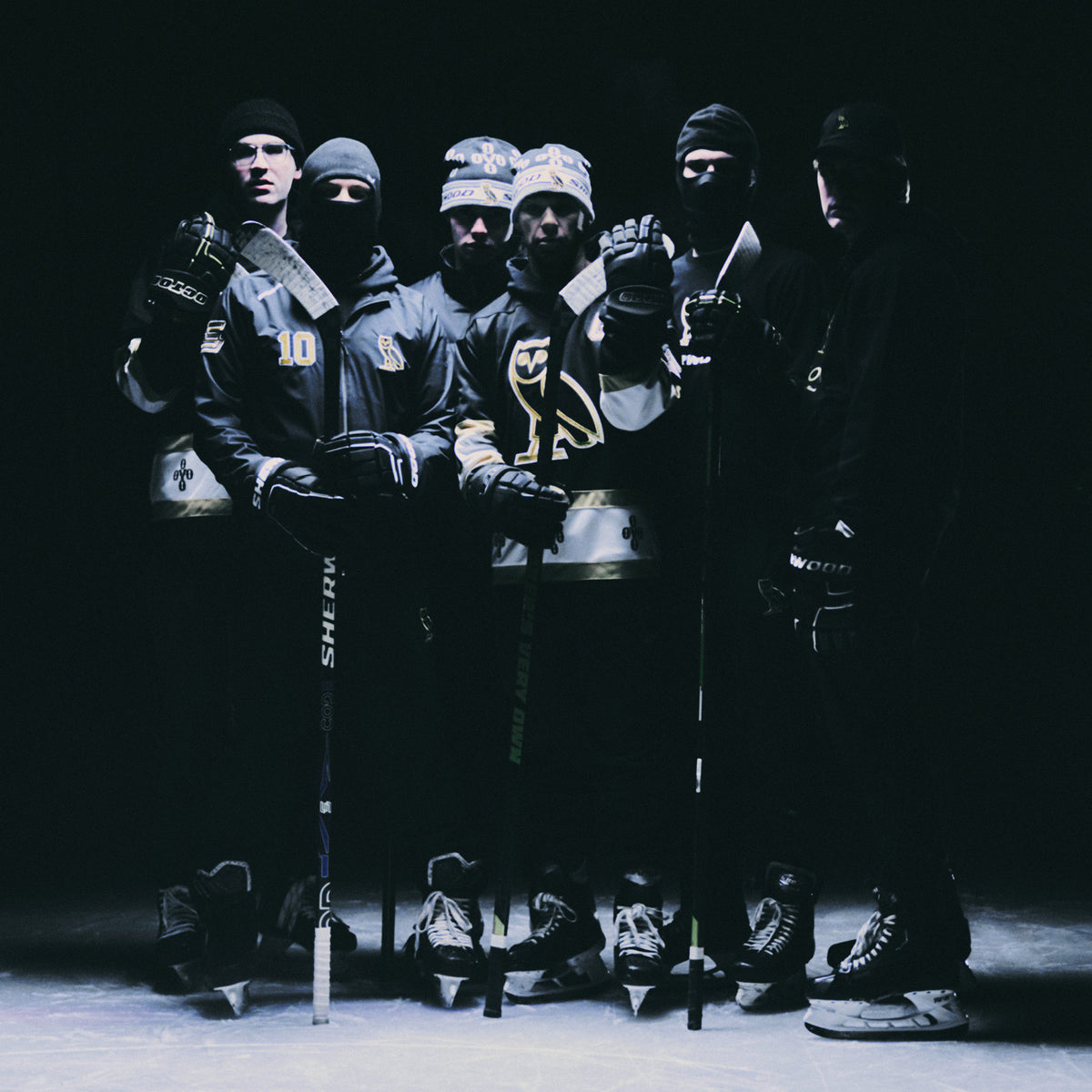 People standing on ice wearing the October's Very Own x Sherwood collection