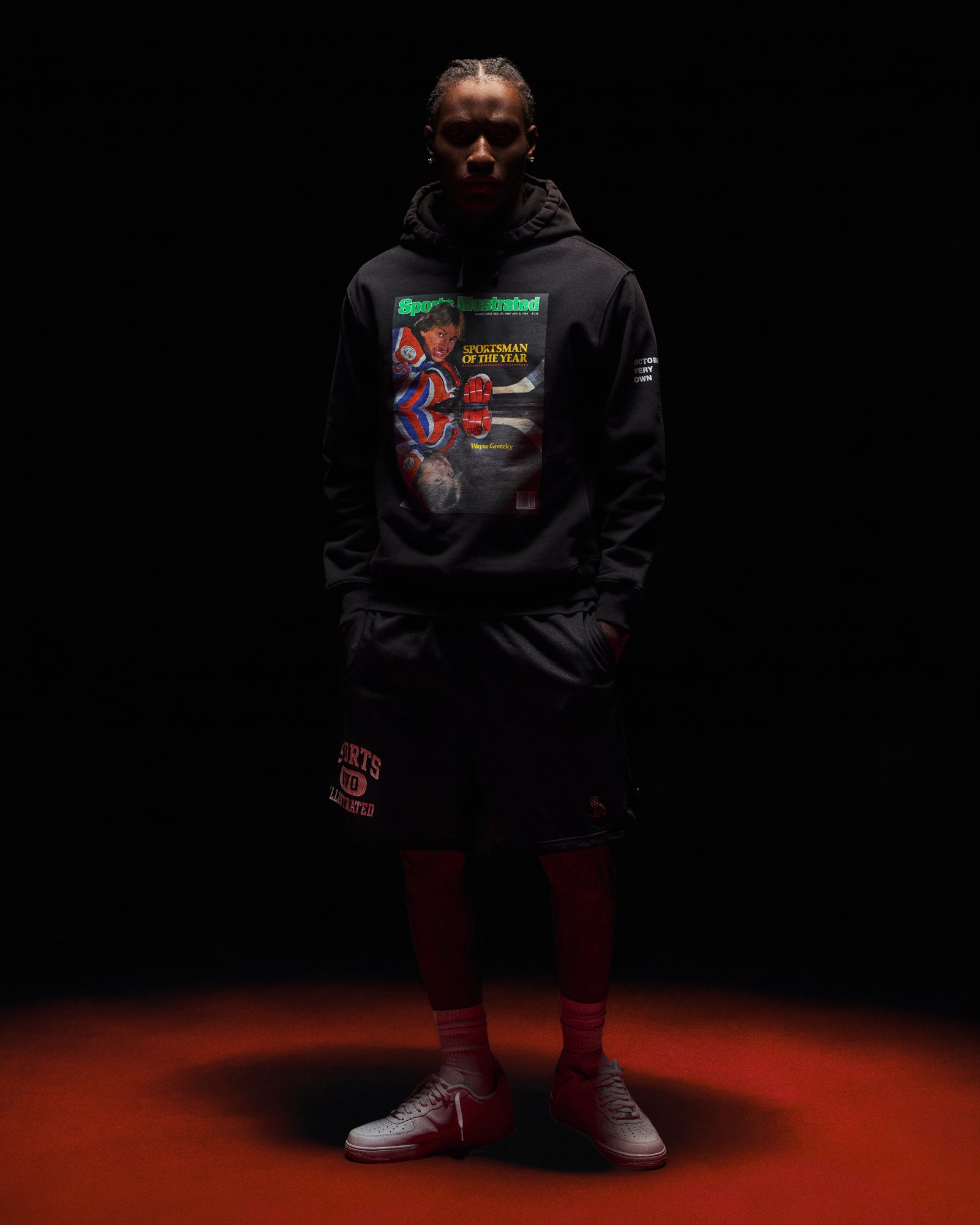 Man wearing October's Very Own x Sports Illustrated Hoodie and Shorts