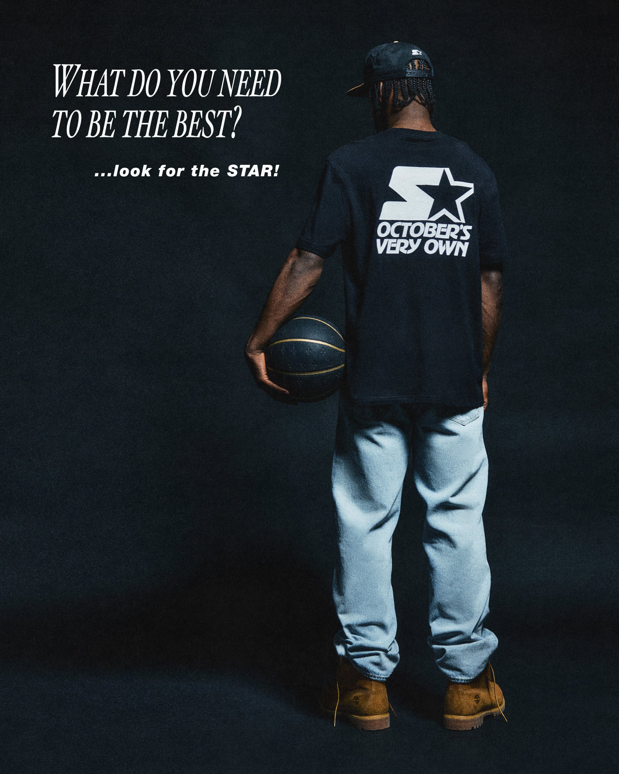 Person holding a basketball with 'October's Very Own' t-shirt on a dark background