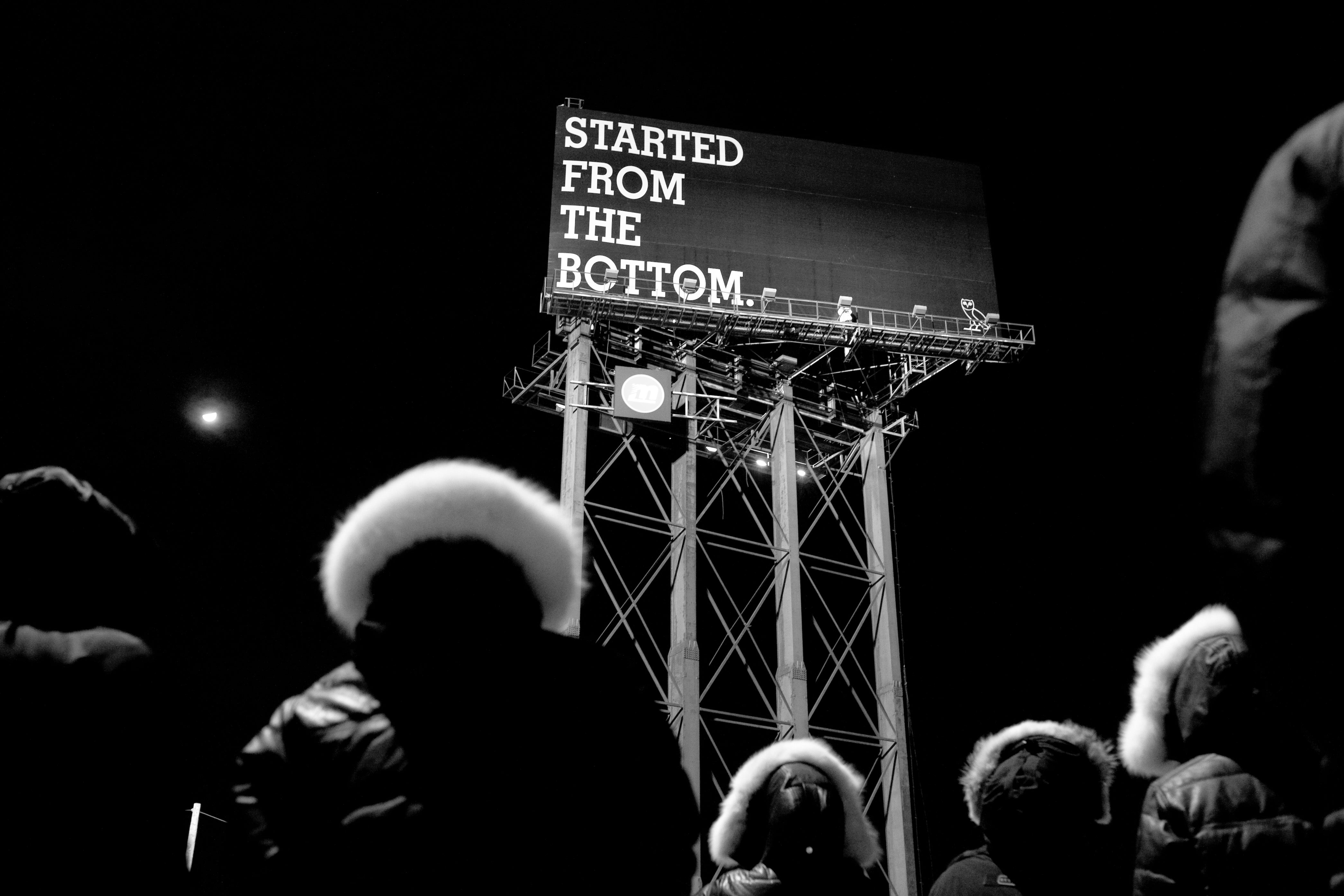 Billboard in the distance that is says "Started From The Bottom" and has a October's Very Own Logo