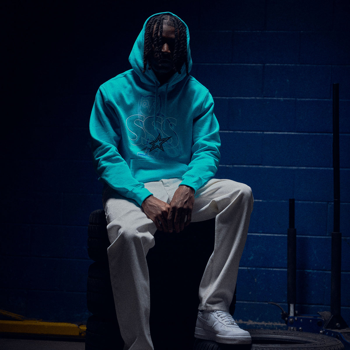 Person wearing a Scarborough Shooting Stars x October's Very Own hooded sweatshirt.