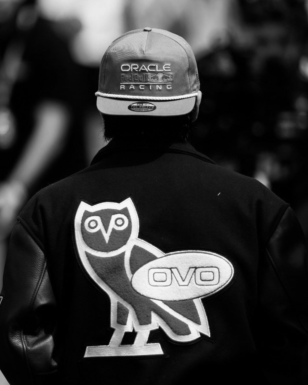 Yuki Tsunoda wearing a October's Very Own x Red Bull Racing Varsity Jacket