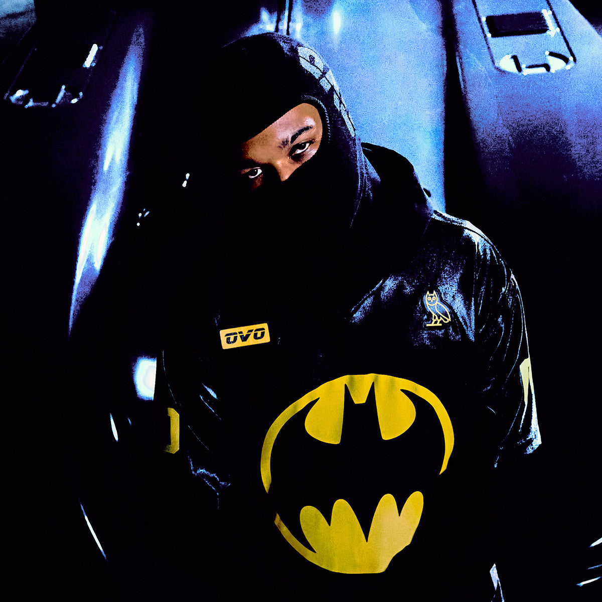 Person wearing a Batman Jersey in a dark setting