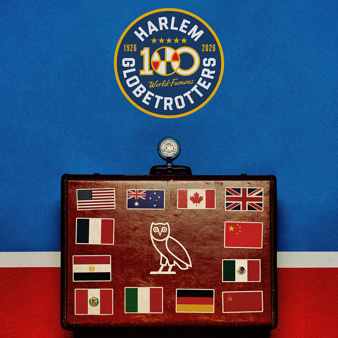 Harlem Globetrotters 100th anniversary logo above a vintage suitcase with world flags on a blue and red background.