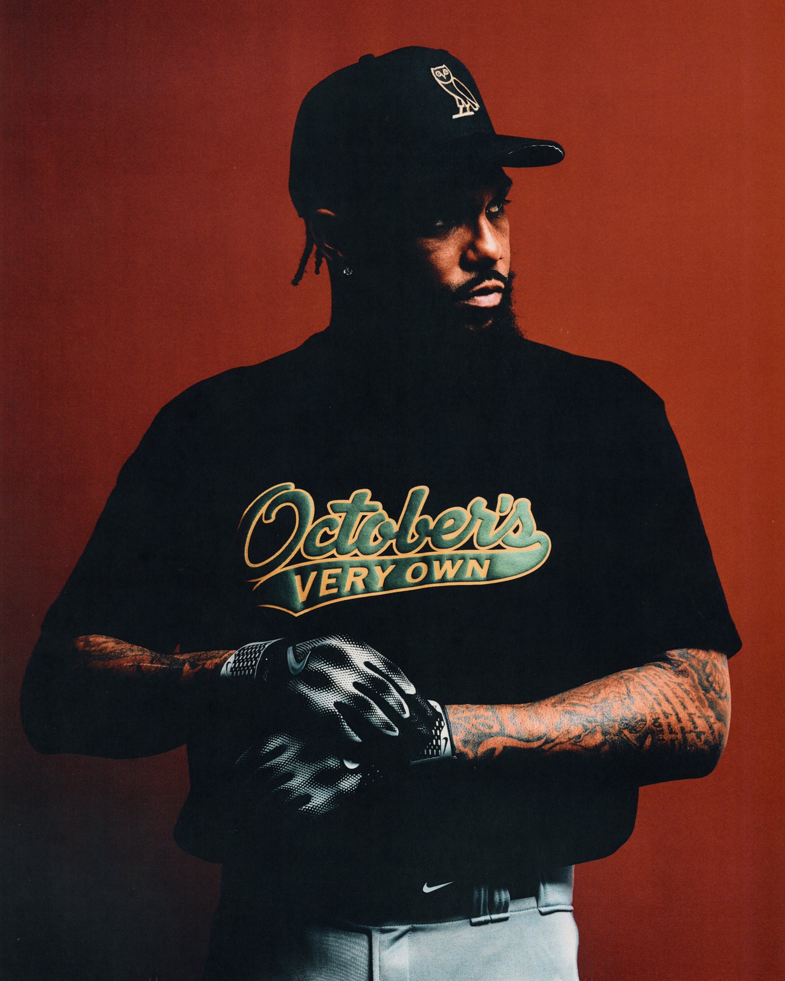 Black t-shirt with gold and teal "Ostchers Very Own" script graphic on chest.