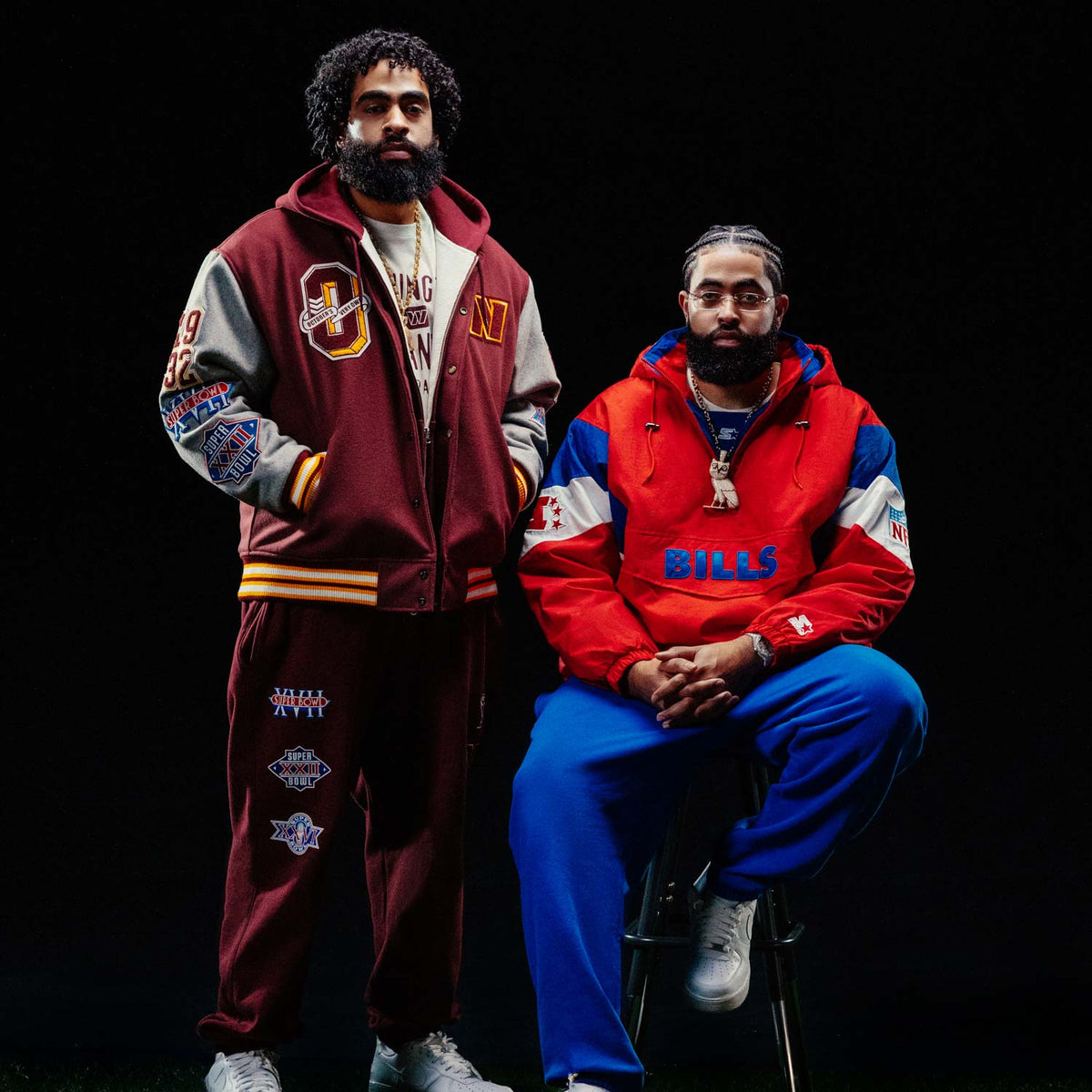 Jae and Trey Richards wearing varsity jackets and pants with October's Very Own logos against a black background