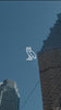 October's Very Own logo overlaying video of buildings