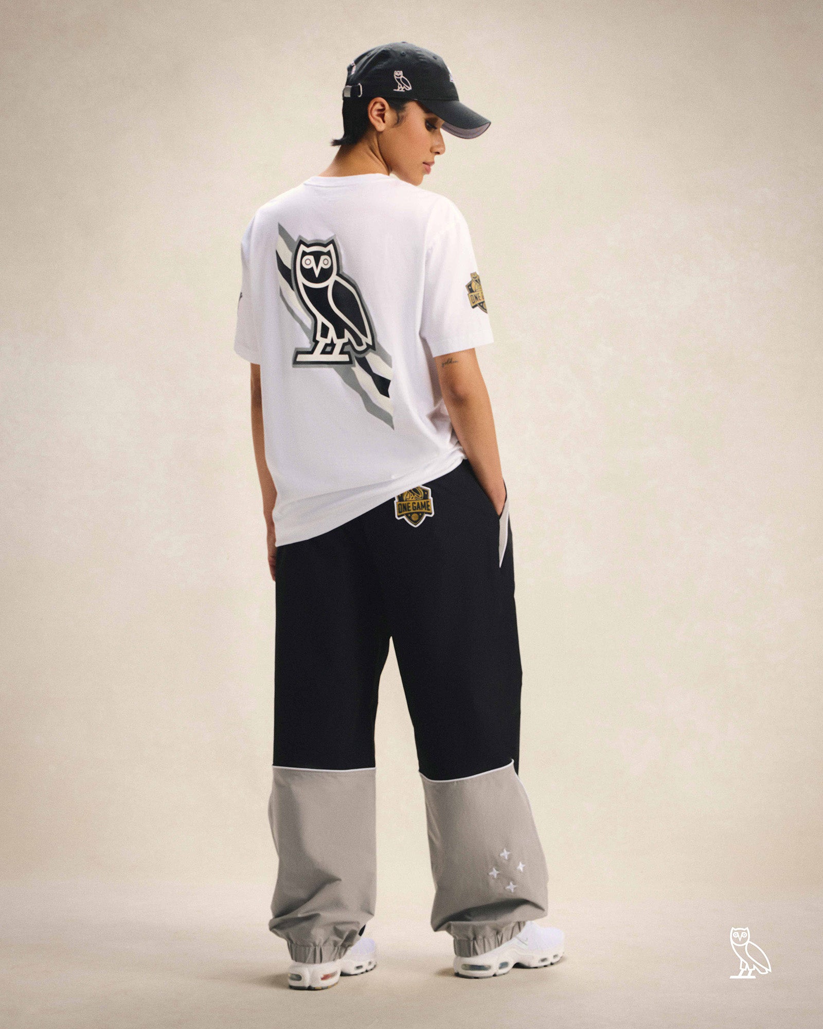 Person wearing October's Very Own / WNBA Hat, T-shirt and track pants