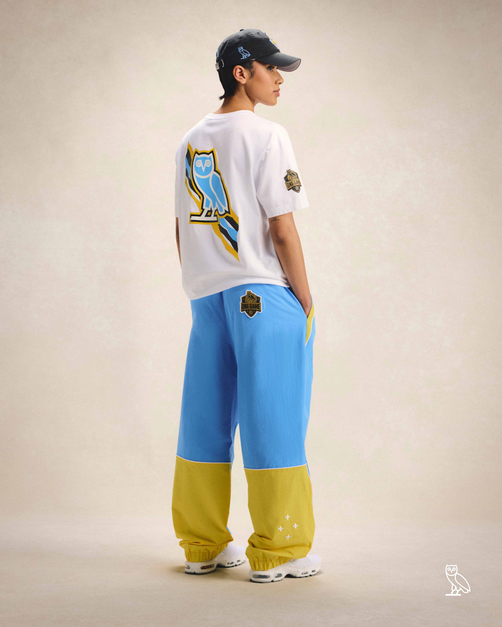 Person wearing October's Very Own / WNBA Hat, T-shirt and track pants